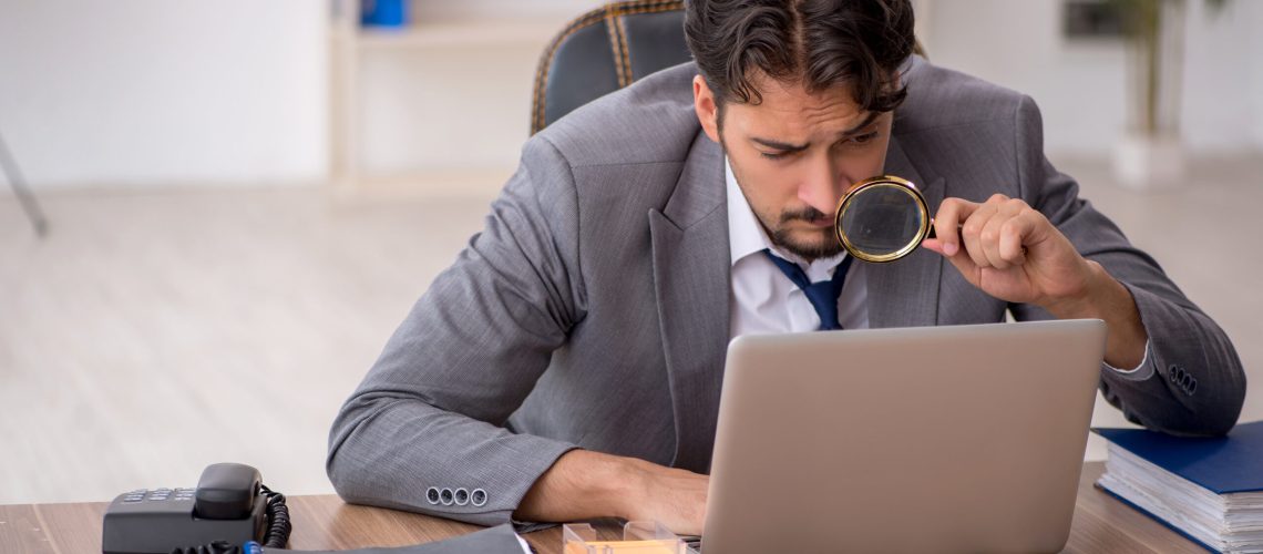 Young businessman employee sitting at workplace